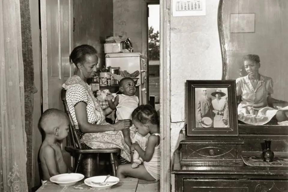 Mrs. Ella Watson, a government charwoman, with three grandchildren and her adopted daughter
